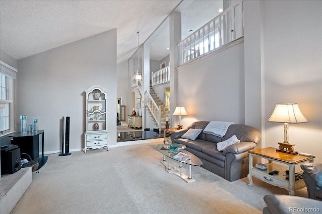 carpeted living room with a high ceiling and a textured ceiling