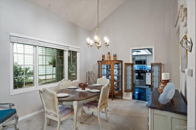 carpeted dining space featuring high vaulted ceiling and a chandelier