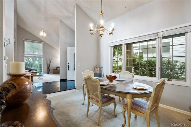 dining space with high vaulted ceiling, a chandelier, light colored carpet, and plenty of natural light