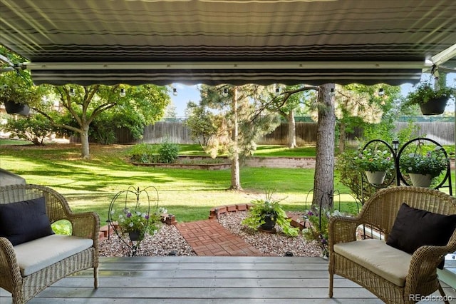 sunroom / solarium featuring a yard and a wooden deck