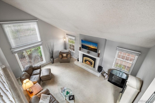 carpeted living room featuring heating unit, vaulted ceiling, and a textured ceiling