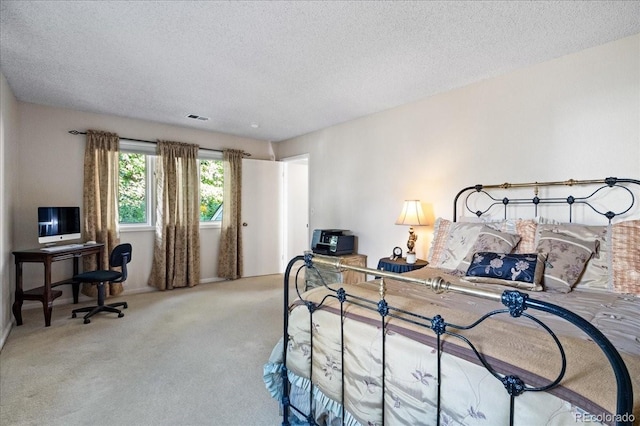 carpeted bedroom featuring a textured ceiling