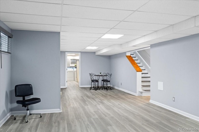 interior space featuring light hardwood / wood-style floors and a drop ceiling