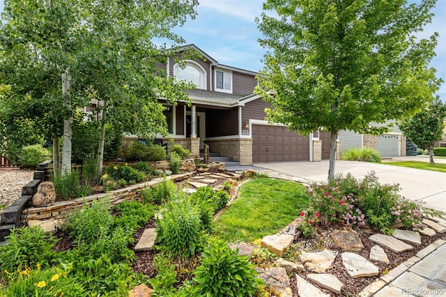 8410 S Oak St, Littleton, CO 80127 - view of front of house with driveway, brick siding, a porch, and an attached garage