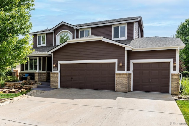 8410 S Oak St, Littleton, CO 80127 - view of front facade with an attached garage, driveway, brick siding, and roof with shingles