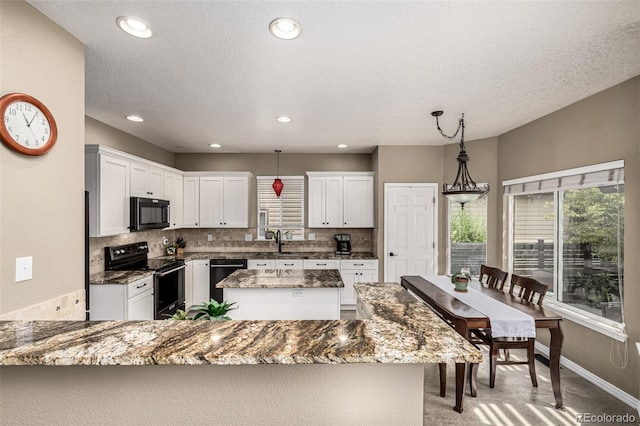 8410 S Oak St, Littleton, CO 80127 - kitchen with black appliances, healthy amount of natural light, dark stone countertops, backsplash, and recessed lighting