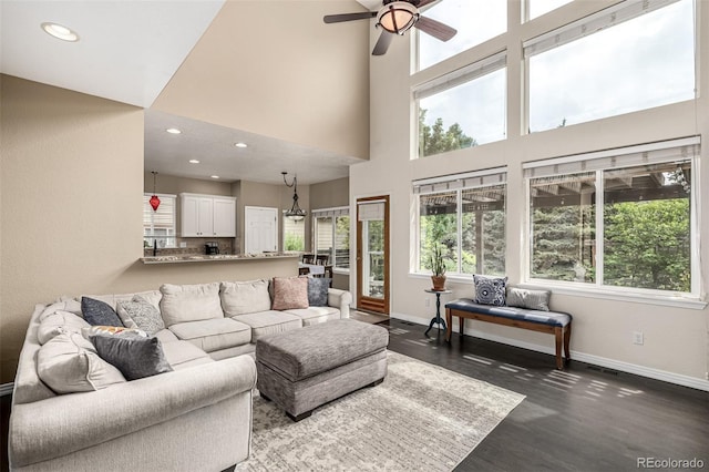 8410 S Oak St, Littleton, CO 80127 - living area featuring dark wood-style floors, ceiling fan, recessed lighting, and a high ceiling