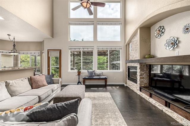 8410 S Oak St, Littleton, CO 80127 - living room with a high ceiling, plenty of natural light, dark wood finished floors, ceiling fan, and a fireplace