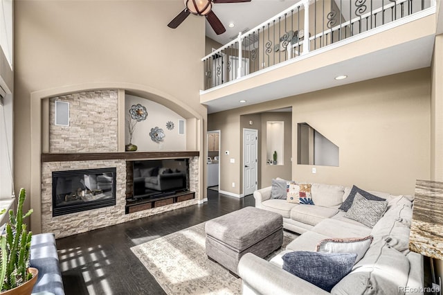 8410 S Oak St, Littleton, CO 80127 - living room featuring a stone fireplace, a ceiling fan, a high ceiling, wood finished floors, and recessed lighting