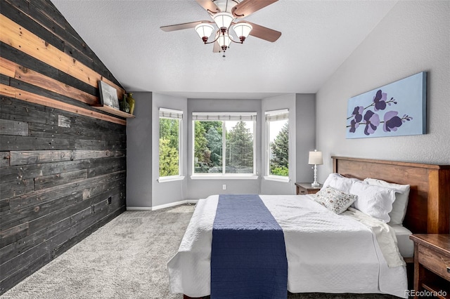 8410 S Oak St, Littleton, CO 80127 - bedroom featuring carpet floors, wood walls, lofted ceiling, a textured ceiling, and a ceiling fan