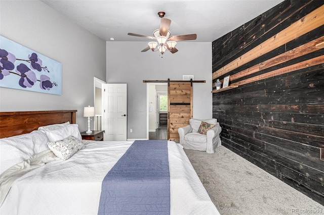 8410 S Oak St, Littleton, CO 80127 - bedroom with a barn door, wooden walls, a high ceiling, and a ceiling fan
