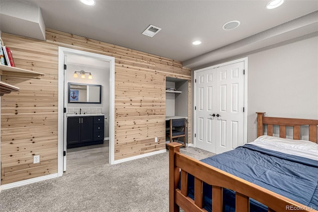 8410 S Oak St, Littleton, CO 80127 - bedroom with wood walls, light carpet, recessed lighting, connected bathroom, and a closet