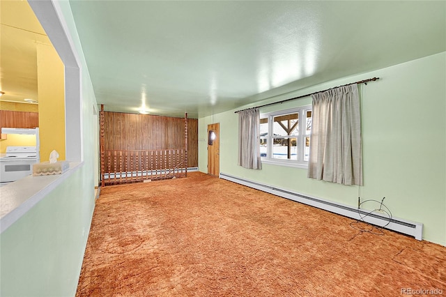 carpeted empty room featuring a baseboard radiator