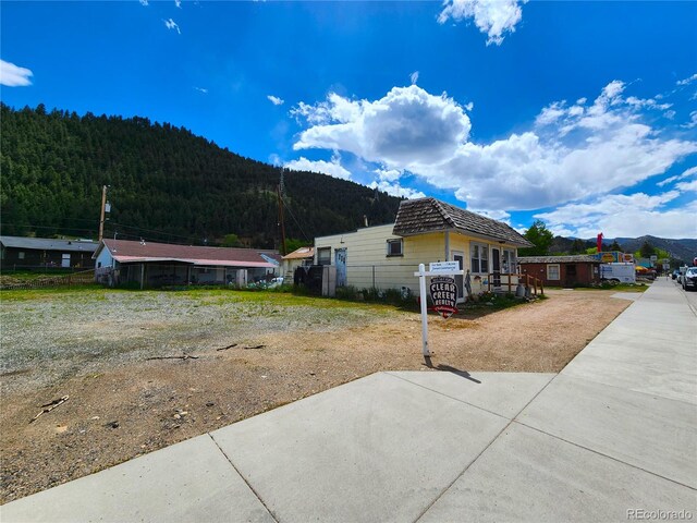 view of side of home with a mountain view