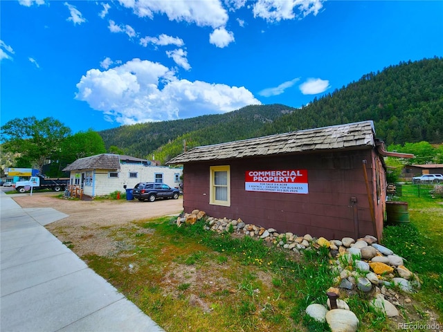 view of side of home with a mountain view