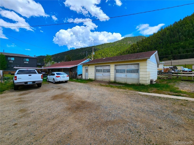 view of front of property featuring a garage and a mountain view