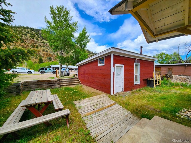 exterior space with a mountain view and a lawn