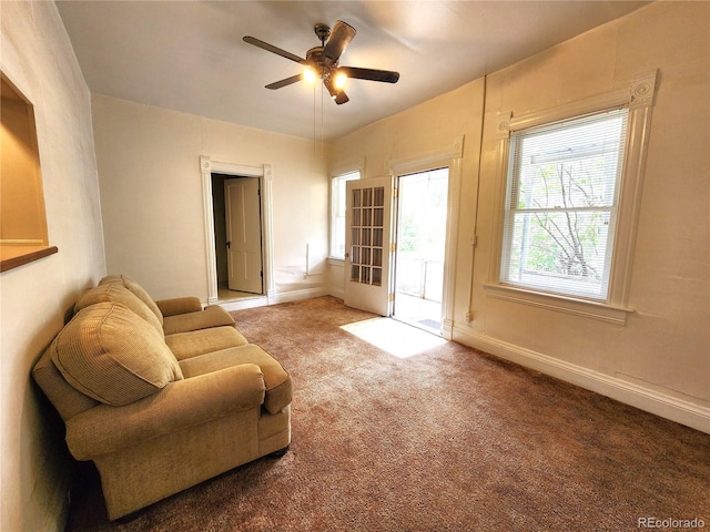 sitting room featuring light carpet and ceiling fan