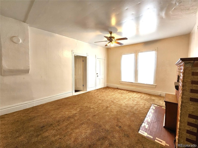 unfurnished living room featuring ceiling fan and light colored carpet