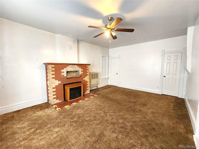 unfurnished living room featuring ceiling fan, carpet, and a brick fireplace