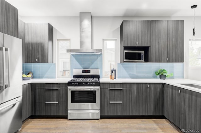 2435 S High St, Denver, CO 80210 - kitchen with appliances with stainless steel finishes, wall chimney exhaust hood, gray cabinetry, and backsplash