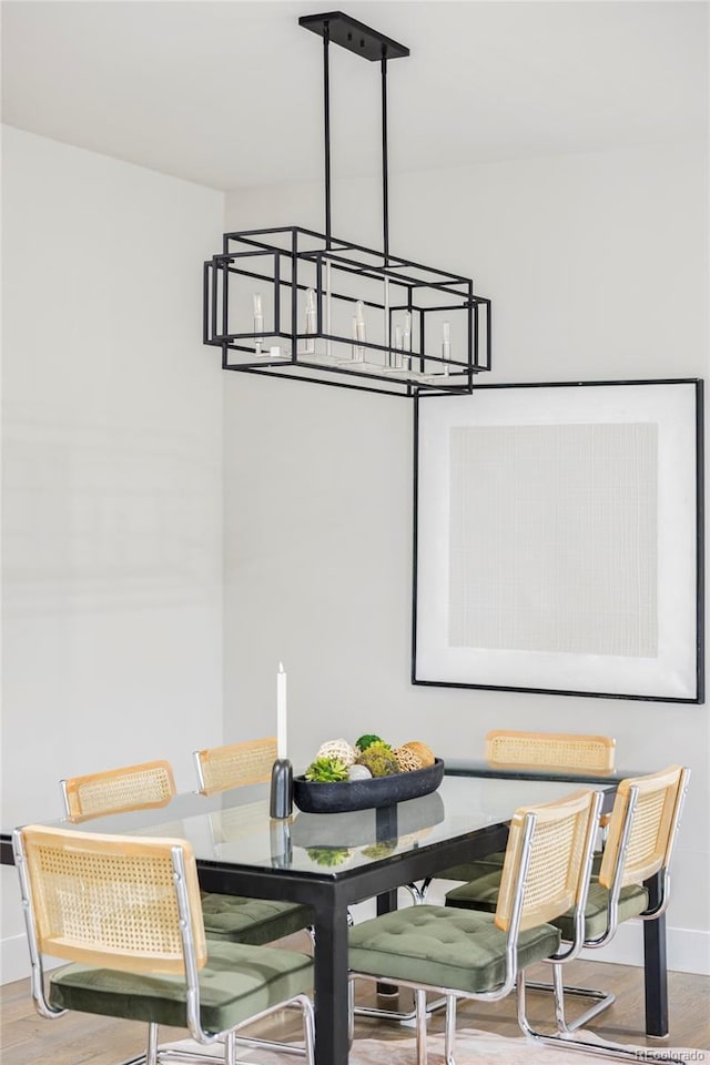 2435 S High St, Denver, CO 80210 - dining room featuring a chandelier, baseboards, and wood finished floors
