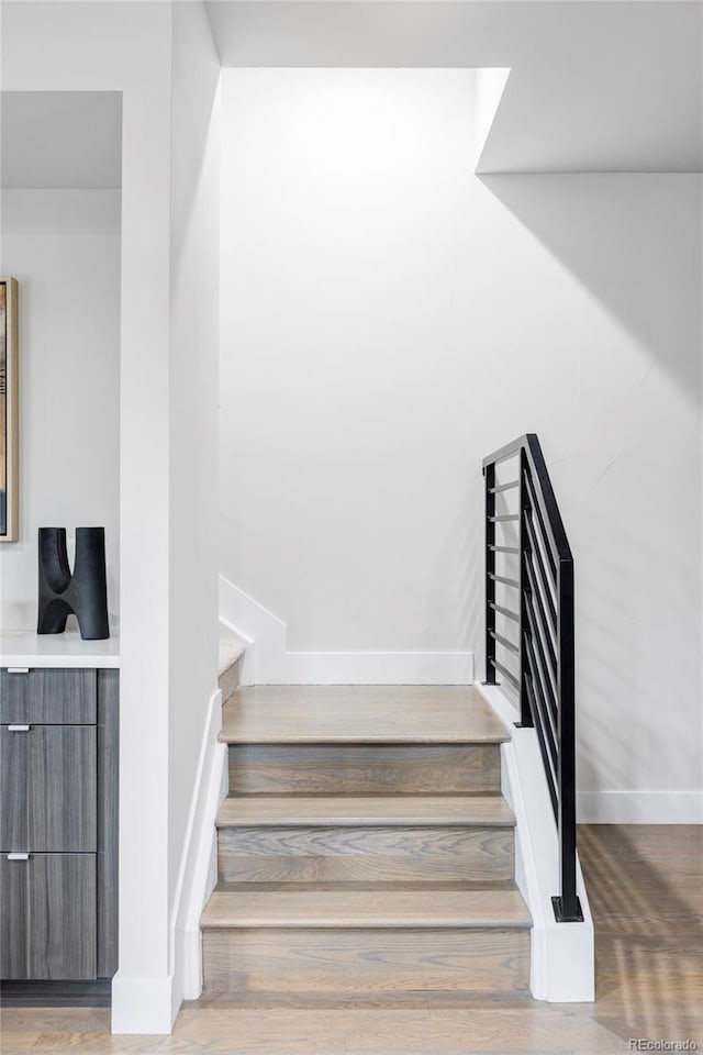 2435 S High St, Denver, CO 80210 - stairs featuring baseboards and wood finished floors