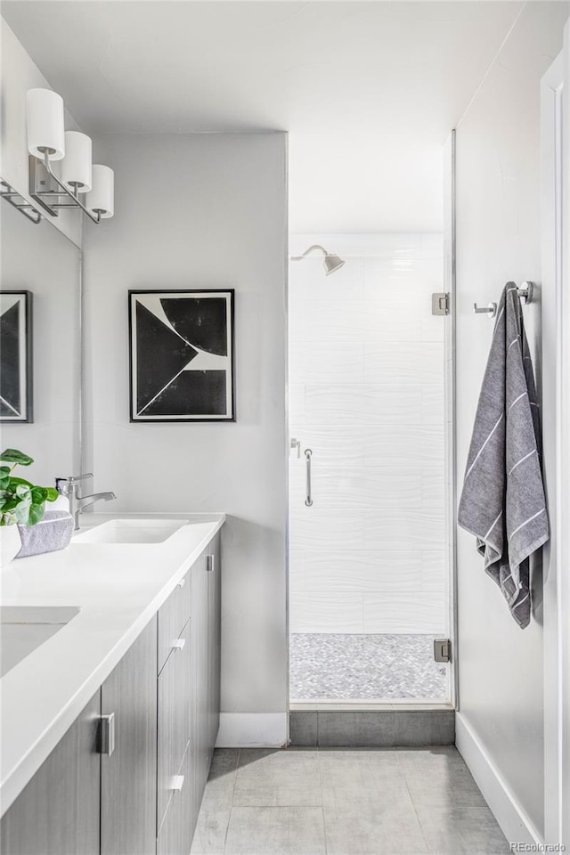 2435 S High St, Denver, CO 80210 - bathroom featuring double vanity, a stall shower, baseboards, and tile patterned floors
