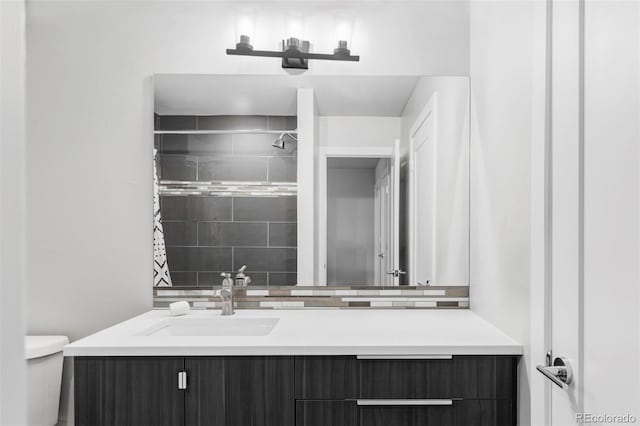 2435 S High St, Denver, CO 80210 - full bath with vanity, toilet, a tile shower, and tasteful backsplash