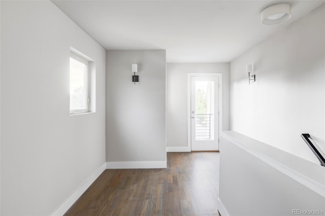 2435 S High St, Denver, CO 80210 - hallway with plenty of natural light, dark wood-type flooring, and baseboards