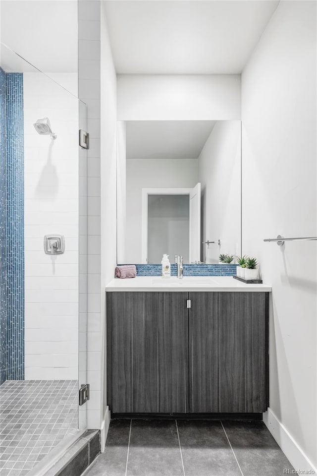 2435 S High St, Denver, CO 80210 - bathroom with a shower stall, vanity, tile patterned flooring, and baseboards