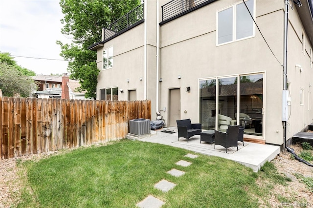 2435 S High St, Denver, CO 80210 - rear view of property featuring stucco siding, a patio, cooling unit, and outdoor lounge area