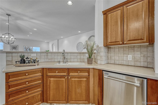 kitchen with decorative backsplash, stainless steel dishwasher, sink, a chandelier, and hanging light fixtures