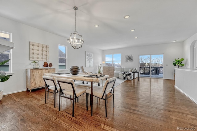 dining room featuring a notable chandelier and dark wood-type flooring