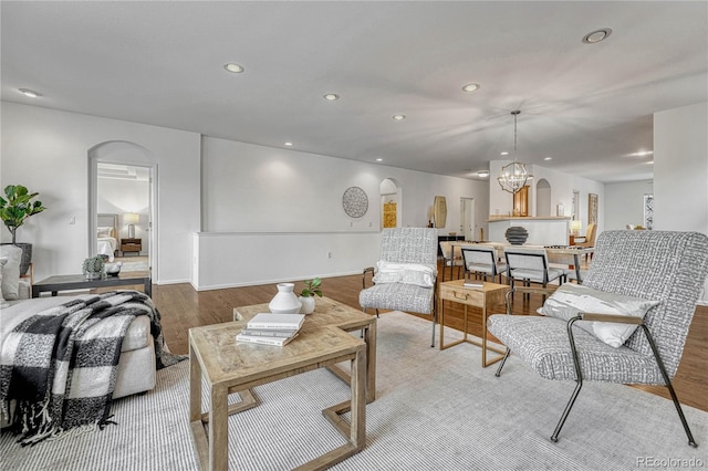 living room with hardwood / wood-style floors and a notable chandelier