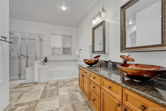 bathroom featuring vanity and shower with separate bathtub