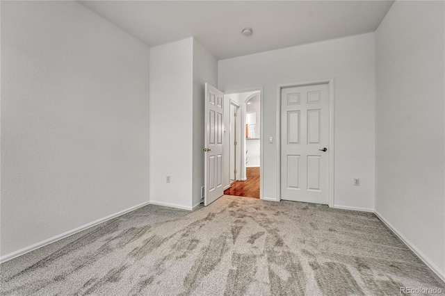 unfurnished bedroom with light colored carpet