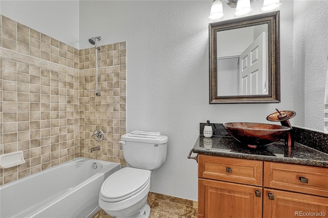 full bathroom featuring tile patterned floors, vanity, toilet, and tiled shower / bath