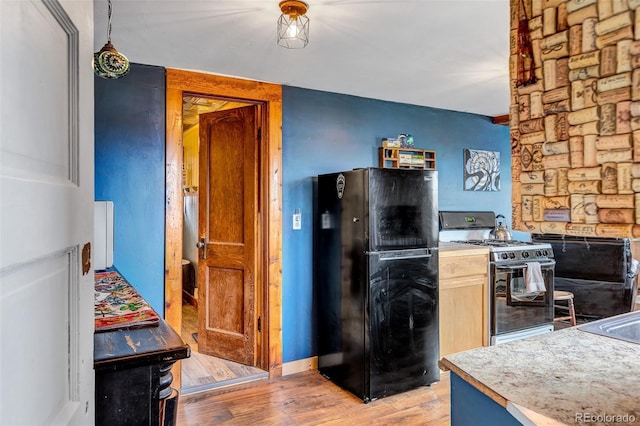 500 Fourth St, Fairplay, CO 80440 - kitchen featuring freestanding refrigerator, range with gas stovetop, light wood-type flooring, and light countertops