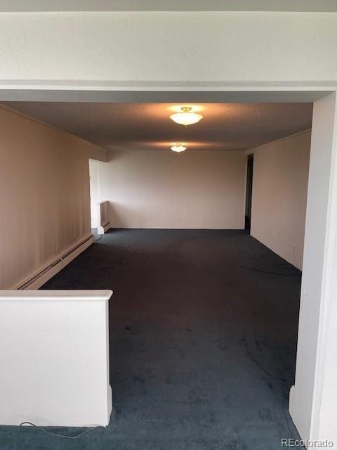 3131 E Alameda Ave Unit 604, Denver, CO 80209 - corridor featuring a baseboard radiator and dark carpet