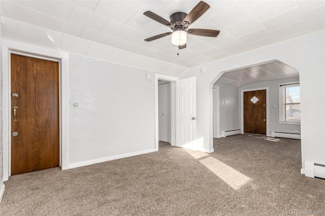 unfurnished living room featuring carpet floors, baseboard heating, and ceiling fan