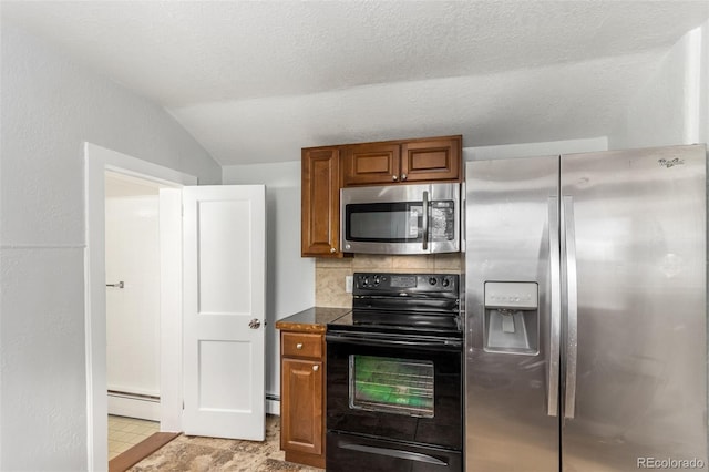 kitchen featuring a baseboard heating unit, backsplash, a textured ceiling, vaulted ceiling, and appliances with stainless steel finishes