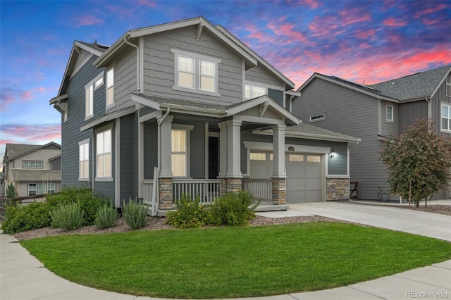 12940 Brier Ct, Firestone, CO 80504 - view of front facade featuring a porch, driveway, a lawn, stone siding, and a garage