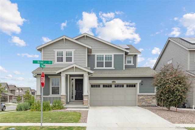 12940 Brier Ct, Firestone, CO 80504 - craftsman inspired home with roof mounted solar panels, stone siding, driveway, a porch, and a garage