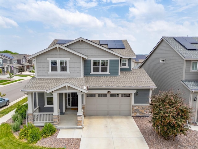 12940 Brier Ct, Firestone, CO 80504 - craftsman-style house featuring covered porch, a shingled roof, concrete driveway, stone siding, and a garage
