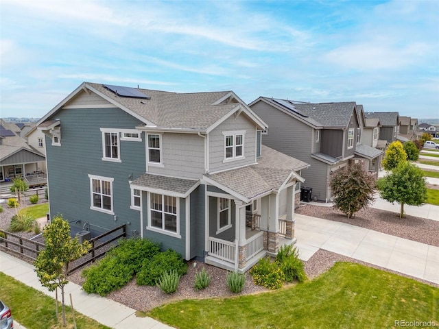 12940 Brier Ct, Firestone, CO 80504 - view of front of house with a shingled roof, concrete driveway, a garage, a residential view, and roof mounted solar panels