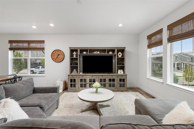 12940 Brier Ct, Firestone, CO 80504 - living area featuring wood finished floors, plenty of natural light, and recessed lighting