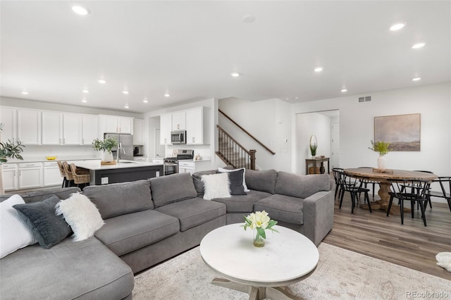 12940 Brier Ct, Firestone, CO 80504 - living room with stairs, recessed lighting, and light wood-style flooring