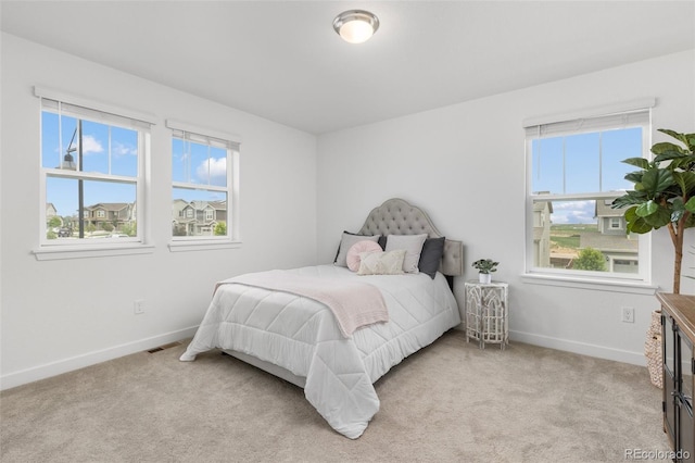 12940 Brier Ct, Firestone, CO 80504 - bedroom with multiple windows and light carpet