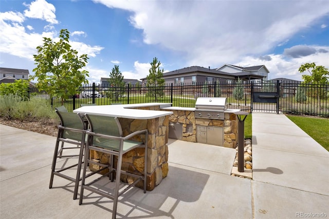12940 Brier Ct, Firestone, CO 80504 - view of patio featuring an outdoor kitchen, a bar, and a gate